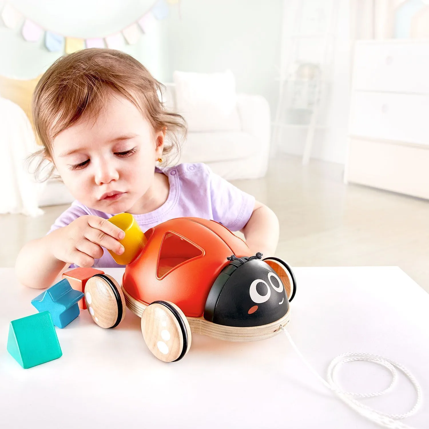 Игрушка каталка-сортер Hape «Божья коровка», 5 предметов